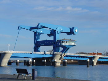 Pier over sea against blue sky