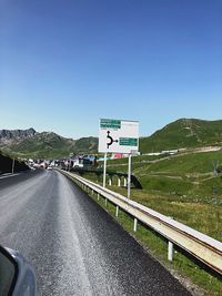 Road sign against clear sky