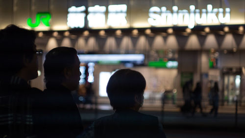 Rear view of people standing at airport