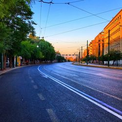 Road in city against clear sky