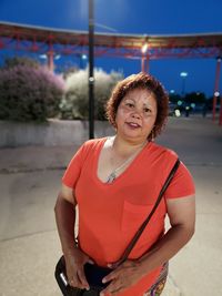 Portrait of smiling woman standing outdoors