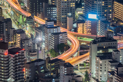 High angle view of illuminated street amidst buildings in city