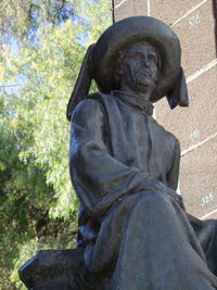 Statue against stone wall