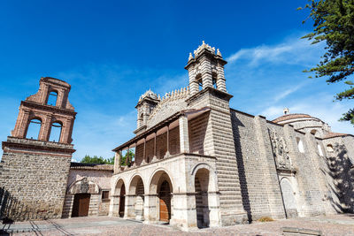 Low angle view of church against blue sky