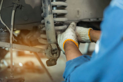 Cropped hand of man working in garage