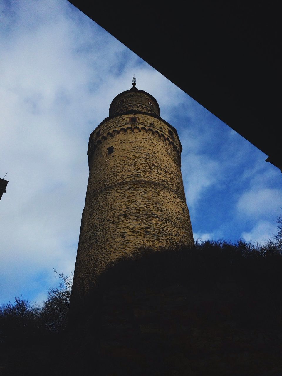 low angle view, architecture, sky, built structure, building exterior, cloud - sky, cloud, tower, famous place, history, travel destinations, blue, tall - high, outdoors, day, international landmark, sunlight, no people, cloudy, tourism