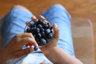 Midsection of woman holding fruits