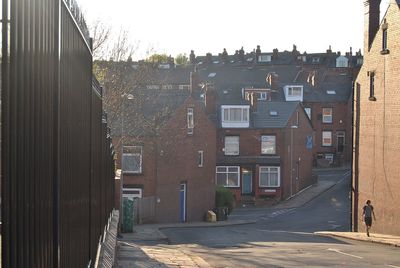 Street amidst buildings in town against sky