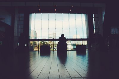 Rear view of silhouette woman walking in corridor