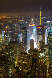 High angle view of illuminated buildings in city at night