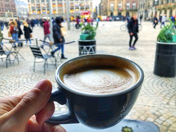 Close-up of coffee cup on street