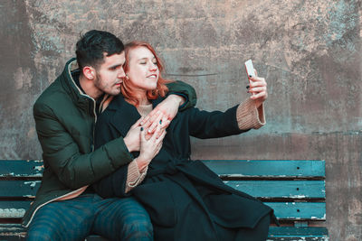 Young couple holding smart phone