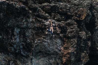 High angle view of man climbing on rock formation