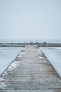 Boardwalk on beach against sky