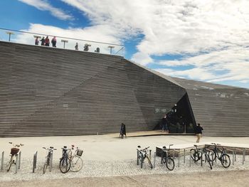 People on bicycle against building