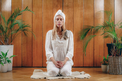 Woman practicing kundalini yoga, kriya exercises for the navel center and bowel waste elimination