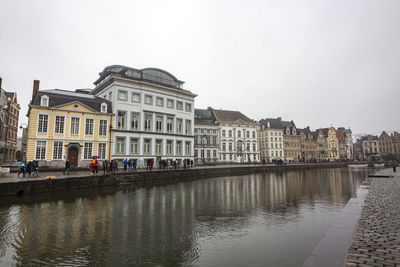 Buildings in city against clear sky