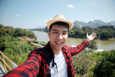 Portrait of smiling young man wearing hat