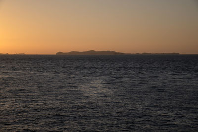 Scenic view of sea against clear sky during sunset