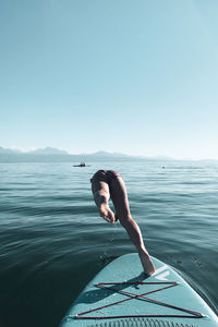 Man on sea against clear sky