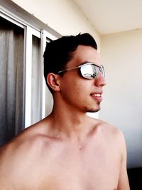 Close-up of shirtless mid adult man at home