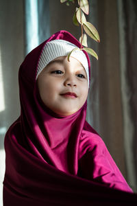 Portrait of a happy muslim toddler girl with hijab. natural light, selective focus.