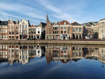 Reflection of buildings in lake against sky