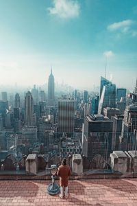 High angle view of man standing at observation point against cityscape