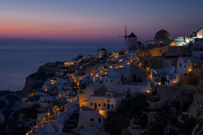 High angle view of seaside city at sunset