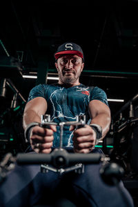 Portrait of young man exercising in gym