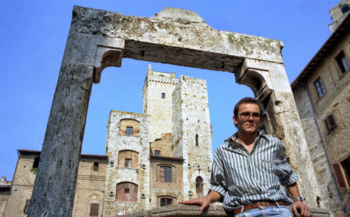 Portrait of man against old building