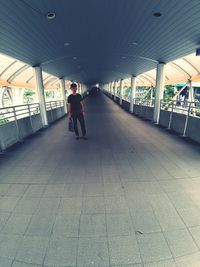 Full length of man standing on tiled floor