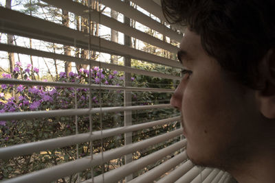 Close-up of man looking at flowering plants