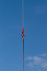 Low angle view of pole against blue sky