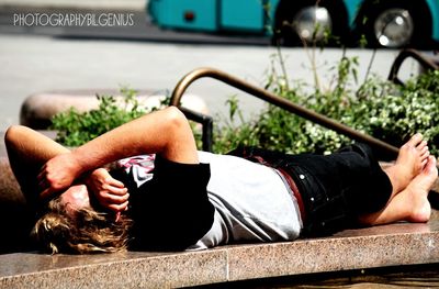 Low section of man resting on plant