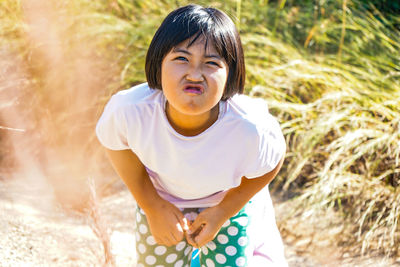 Portrait of cute girl standing on land