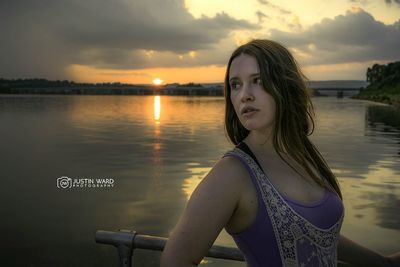 Silhouette of woman in lake at sunset