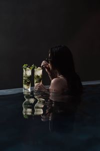 Side view of a woman drinking water