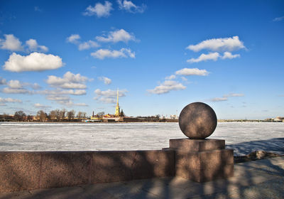 Retaining wall by neva river against sky