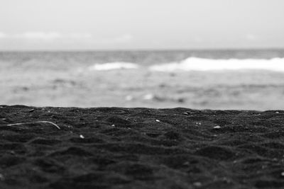 Close-up of sand on beach against sky