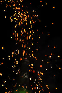 Low angle view of firework display at night