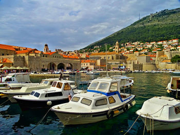 Aerial view of townscape by sea against sky