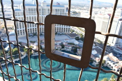 Close-up of metal railing by river
