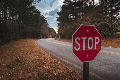 Close-up of road sign against sky