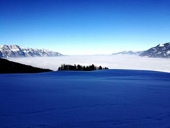 Scenic view of frozen lake against blue sky