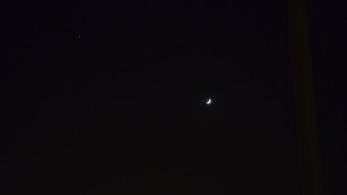 Low angle view of moon against sky at night