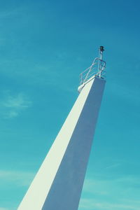 Low angle view of tower against blue sky