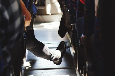 Low section of woman sitting in bus