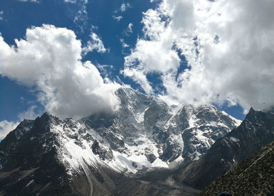 Aerial view of snowcapped mountains against sky