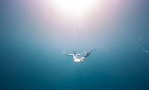 Low angle view of woman swimming underwater
